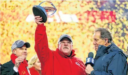  ?? MARK J. REBILAS/USA TODAY SPORTS ?? Kansas City Chiefs head coach Andy Reid celebrates with the Lamar Hunt Trophy after beating the Tennessee Titans in the AFC Championsh­ip Game on Sunday.