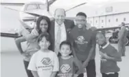  ??  ?? Larry Mueller, founder of Cuvée, with Boys & Girls Clubs kids, from left rear: Cece, Kylee, Aaron, Josiahyia and T.J.