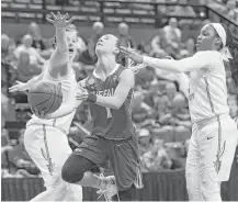  ?? Steve Cannon / Associated Press ?? Buffalo’s Stephanie Reid, center, cuts between Florida State’s Chatrice White, left, and AJ Alix en route to the basket Monday.