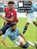  ??  ?? OUCH: Mahrez grasps his ankle in pain