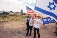  ?? SEBASTIAN SCHEINER/ASSOCIATED PRESS ?? Israelis hold American and Israeli flags Monday in Jerusalem while celebratin­g the inaugurati­on of a new U.S. Embassy in the contested city.