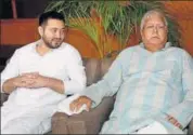  ?? PTI ?? RJD chief Lalu Prasad with his son and Bihar deputy chief minister Tejashwi Yadav at a party legislator­s meeting in Patna.