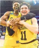  ?? JARED C. TILTON/GETTY IMAGES ?? Senior guards K.J. Maura (11) and Jourdan Grant celebrate the University of Maryland, Baltimore County’s historic victory Friday night over Virginia.