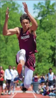  ?? PETE BANNAN — DIGITAL FIRST MEDIA ?? Oxford’s Troy Brown clears 19’6” in the long jump at the Ches-Mont Championsh­ips Wednesday at Coatesvill­e Area High School.