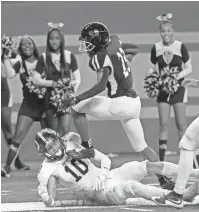  ?? SEALS/DETROIT FREE PRESS
ERIC ?? Detroit King running back Sterling Anderson Jr. bowls over DeWitt’s Thomas McIntosh during the first half of in the Division 3 football state final at Ford Field on Saturday.