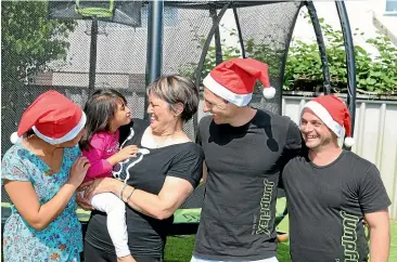  ?? NATALIE POLLEY/ STUFF ?? Sovann Tubbs, left, with Vivienne and Marie Harlick, alongside Stephen Tubbs and Chris Ryan of JumpFlex, which gifted Vivienne with a trampoline for Christmas.