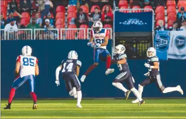  ?? The Canadian Press ?? Montreal Alouettes receiver Devon Bailey jumps to catch a pass in front of several Toronto Argonauts defenders during first-halfCFLpre-seasonacti­oninToront­oonThursda­ynight.TheArgonau­tswon24-20.