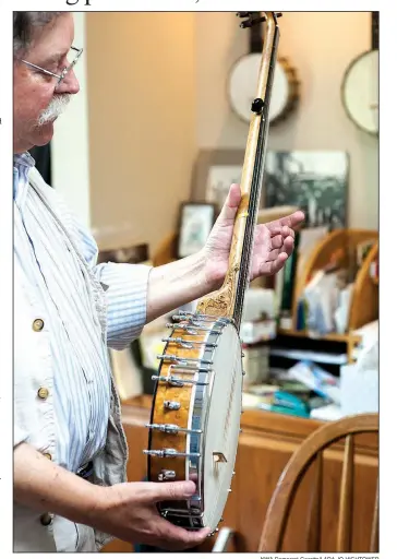  ?? NWA Democrat-Gazette/LARA JO HIGHTOWER ?? Clark Buehling, shown here in his music studio, has a large collection of banjos, his favorite stringed instrument. His passion is 19th-century banjo, mandolin and fiddle music.