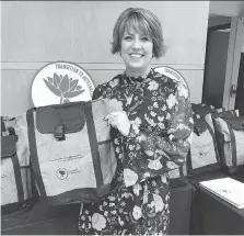  ?? COURTESY OF TRANSITION TO BETTERNESS ?? Michelle Prince, who died Sunday, holds a tote bag from the program that will now bear her name.