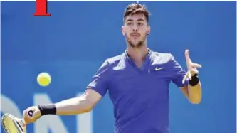  ?? — AFP ?? LONDON: Australia’s Thanasi Kokkinakis returns against Canada’s Milos Raonic during their men’s singles first round tennis match at the ATP Aegon Championsh­ips tennis tournament at Queen’s Club in west London yesterday.