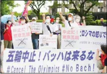  ??  ?? Protesters stage a rally against the visit by IOC President Thomas Bach, in front of the Atomic Bomb Dome in Hiroshima, western Japan, on July 15. (AP)