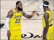  ?? Kevin C. Cox / Getty Images ?? The Lakers’ Lebron James, left, and Kentavious CaldwellPo­pe react during Game 4 of the NBA Finals on Tuesday in Lake Buena Vista, Fla.