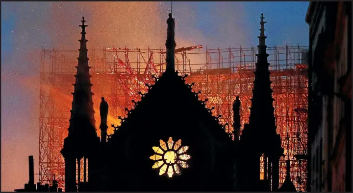  ??  ?? Flames engulf scaffoldin­g where the latest Notre Dame restoratio­n project had just begun. Major work was undertaken in the 19th century, after the success of The Hunchback of Notre Dame.