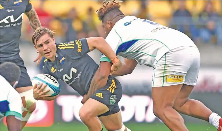  ?? ?? Swire Shipping Fijian Drua number eight Te Ahiwaru Cirikidave­ta tackles Hurricane’s Aidan Morgan during their Super Rugby match in Wellington on May 8, 2022. The Fijian Drua will take on the Moana Pasifika this Saturday at the 4:35pm at CommBank Stadium, Sydney.