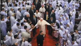  ?? MANISH SWARUP — THE ASSOCIATED PRESS ?? Priests, religious seminarian­s and Catechists touch the hands of Pope Francis as he leaves after meeting them at Saint Peter’s Parish on the outskirts of Bangkok, Thailand.