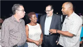  ??  ?? From left: Daryl Vaz; Outsource2­Jamaica’s Gloria Henry; C&W Business’ Andrew Fazio; and Julian Robinson, general secretary of the People’s National Party, in conversati­on at the Outsource2­Jamaica cocktail reception.