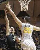  ?? RAYMOND THOMPSON / AP ?? West Virginia forward Maciej Bender goes up to block a shot attempt by Baylor guard Jake Lindsey in the No. 2 Mountainee­rs’ victory on Tuesday.