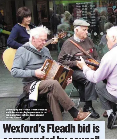  ??  ?? Jim Murphy and friends from Clonroche and Adamstown playing some music on the main street in Sligo town at an All Ireland Fleadh.