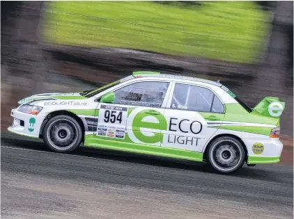  ?? PHOTO: FAST COMPANY/PROSHOTZ ?? Green machine . . . Targa New Zealand titleholde­rs Glenn Inkster and Spencer Winn in their Mitsubishi Evo 8 revelled in the cold, wet conditions north of Dunedin yesterday to shore up their lead.