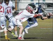  ?? GENE WALSH — DIGITAL FIRST MEDIA ?? Cardinal O’Hara’s James Kutufaris loses control of a pass as he is hit by Upper Dublin’s Anthony Cerminara Monday.