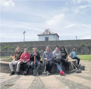  ??  ?? Year 9 and 10 pupils from Porthcawl Comprehens­ive School have given the town’s Cosy Corner a facelift as part of the community project section of the Welsh Baccalaure­ate