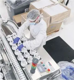  ??  ?? BELOW
A worker at the Christian Dior cosmetics and perfume factory in Jean-de-Braye making hand sanitisers to be given for free to Paris hispitals.