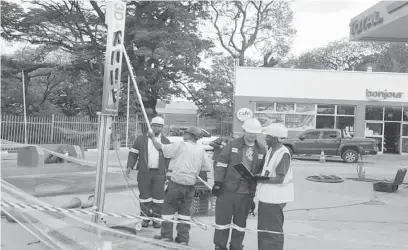  ??  ?? Garage and Forecourt (Pvt) Ltd Managing Director Omalli Jani (far left) and the company’s technician­s at work at a Total garage