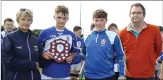  ??  ?? Joint captains Adam Roche and Conor Murphy with Angela McCormack (Coiste na nOg) and Dean Goodison, representi­ng People Newspapers.