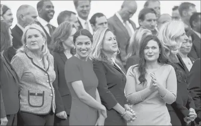  ?? MELINA MARA/THE WASHINGTON POST ?? Alexandria Ocasio-Cortez, center, stands on the steps of the U.S. Capitol with other newly elected members of Congress.