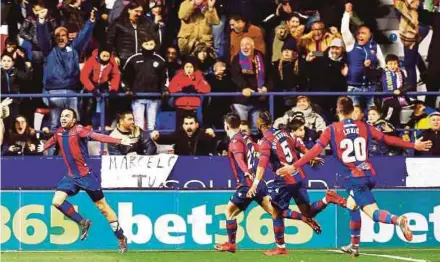  ?? EPA PIC ?? Levante’s Giampaolo Pazzini (left) celebrates with teammates after scoring the equaliser against Real Madrid in a La Liga match in Valencia on Saturday.