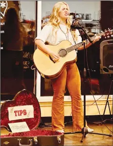  ?? Special to the saline courier ?? Bailey Rhea strums her guitar and performs at a local gig.