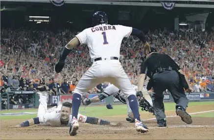  ?? David J. Phillip Associated Press ?? YULI GURRIEL scores around New York Yankees catcher Gary Sanchez moments after Houston Astros teammate Carlos Correa in a three-run fifth inning as Correa and plate umpire Mark Carlson watch. Houston will play the Dodgers in the World Series.