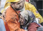  ??  ?? A woman reacts after being told her brother died following an explosion and fire in a coal mine in the western Turkish
province of Manisa.