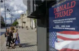  ?? ALIK KEPLICZ — THE ASSOCIATED PRESS ?? Women walk by a poster advertisin­g U.S. President Donald Trump’s speech, that reads “Donald Trump. First Public Appearance in Europe”, in Warsaw, Poland.