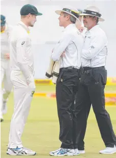  ?? Picture: PETER HEEGER ?? Umpires Nigel Llong and Richard Illingwort­h confronts Cameron Bancroft after he was seen ball tampering.