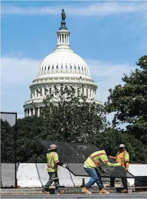  ?? (Reuters) ?? Workers remove security fencing as a reduction in heightened security measures taken after the January 6 on the US Capitol in Washington.