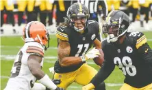  ?? THE ASSOCIATED PRESS ?? Pittsburgh wide receiver Chase Claypool runs past Cleveland cornerback Terrance Mitchell to follow blocking by running back Jaylen Samuels on his way to his sixth TD of the season on Sunday.