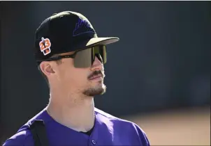  ?? RJ SANGOSTI — THE DENVER POST ?? Rockies outfielder Brenton Doyle walks on the field for practice during spring training at Salt River Fields at Talking Stick on Thursday in Scottsdale, Ariz.