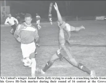  ??  ?? NA United’s winger Jamal Butts (left) trying to evade a crunching tackle from his Grove Hi-Tech marker during their round of 16 contest at the Grove Community ground, East Bank of Demerara.