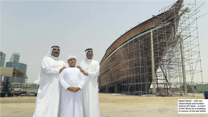  ??  ?? Majid Obaid – with son Obaid Majid and brother Ahmed Al Falasi – in front of the dhow he is building in honour of his late father