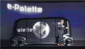  ??  ?? SELFDRIVIN­G STORES. Toyota Motor Corp. president Akio Toyoda introduces the e-Pallet concept, a selfdrivin­g minibus that serves as a small store.