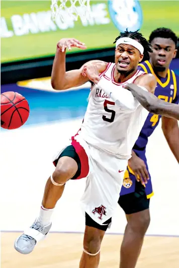  ?? Associated Press ?? ■ Arkansas' Moses Moody loses the ball as he drives against LSU on Saturday during the second half of the Southeaste­rn Conference Tournament in Nashville, Tenn.