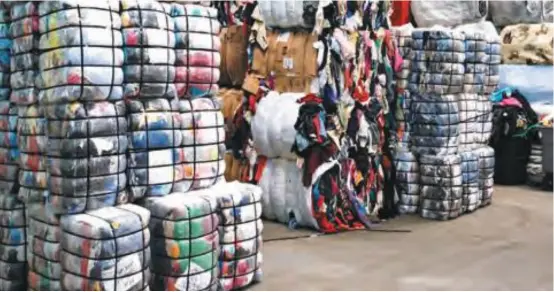  ??  ?? Bales of second-hand clothes at a warehouse.