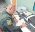  ?? Ben Dickmann, via The Associated Press ?? Deputy Ben Dickmann processes paperwork for the Broward County Sheriff ’s Office in Fort Lauderdale, Fla., to take possession of and destroy his rifle.