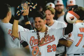  ?? JULIO CORTEZ/AP ?? Ramón Urías is greeted in the dugout after hitting a two-run home run to give the Orioles the lead in a 5-3 win over the Rays on Tuesday night. Urías is hitting .354 in 19 games this month, with five homers, three doubles and 18 RBIs.