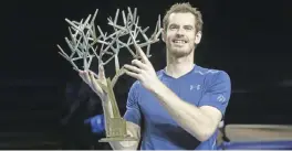  ?? —AP ?? PARIS: Britain’s Andy Murray holds the trophy after winning the final of the Paris Masters tennis tournament against John Isner of the United States in three sets 6-3, 6-7, 6-4 at the Bercy Arena in Paris, yesterday.