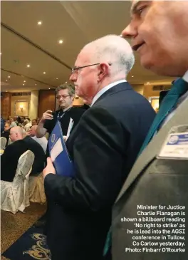  ??  ?? Minister for Juctice Charlie Flanagan is shown a billboard reading ‘No right to strike’ as he is lead into the AGSI conference in Tullow, Co Carlow yesterday. Photo: Finbarr O’Rourke