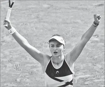  ?? Christophe Ena Associated Press ?? BARBORA KREJCIKOVA celebrates after defeating Anastasia Pavlyuchen­kova 6-1, 2-6, 6-4 in the women’s singles final at Roland Garros. Krejcikova will also play in today’s doubles final with Katerina Siniakova.