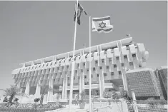  ??  ?? An Israeli flag flutters outside the Bank of Israel building in Jerusalem. Israel’s top court on Sunday struck down a landmark deal regulating exploitati­on of Mediterran­ean gas reserves, in a major defeat for Prime Minister Benjamin Netanyahu who...