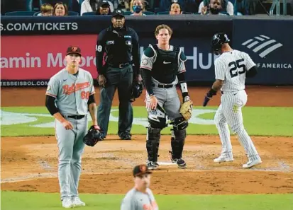  ?? FRANK FRANKLIN II/AP ?? The Yankees’ Gleyber Torres scores on a throwing error by Orioles catcher Adley Rutschman, center, during the fourth inning Wednesday in New York.